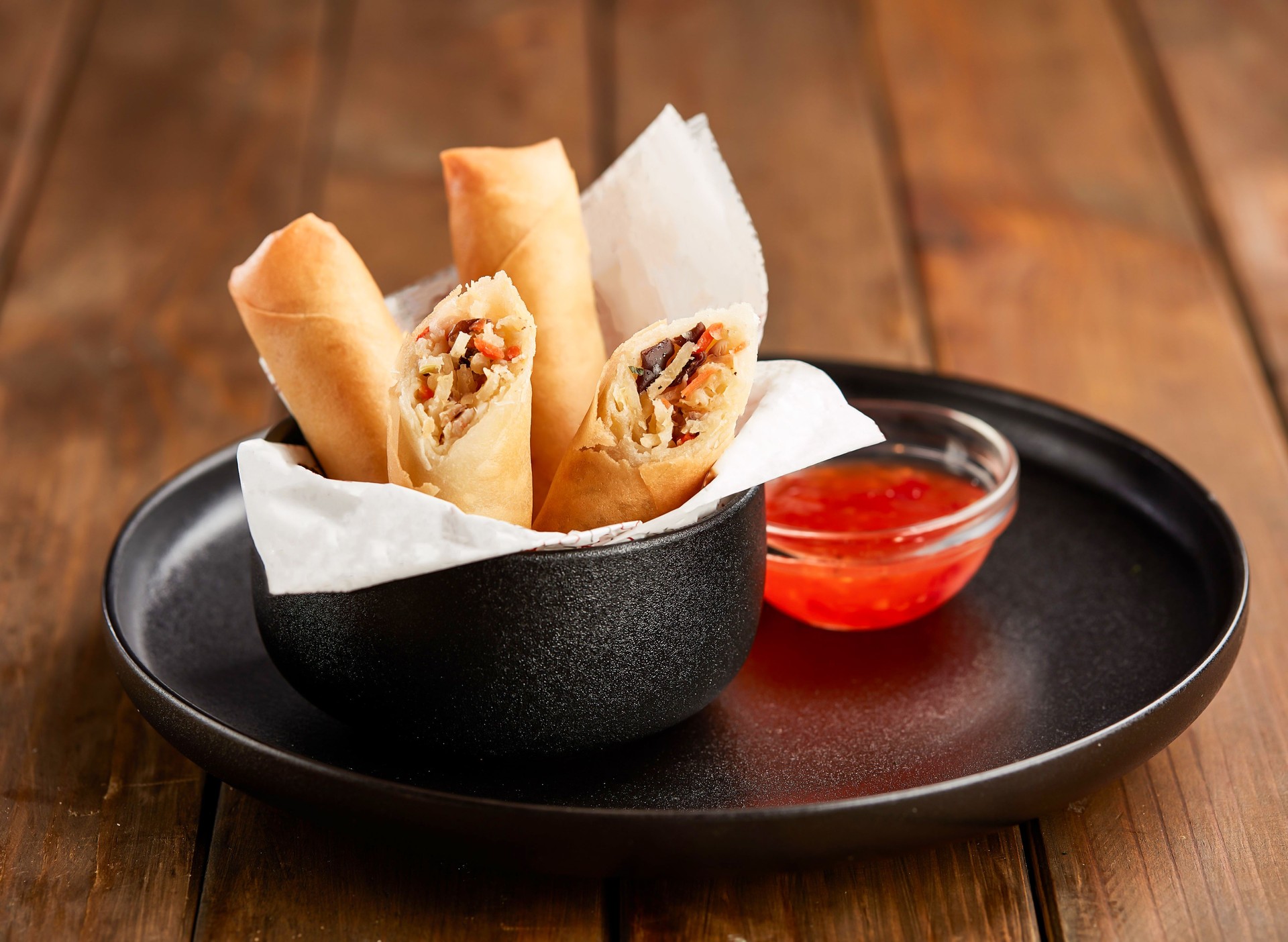Crispy Vegetable Spring Rolls with Sweet Chili Dipping Sauce in plate side view of Asian Appetizer